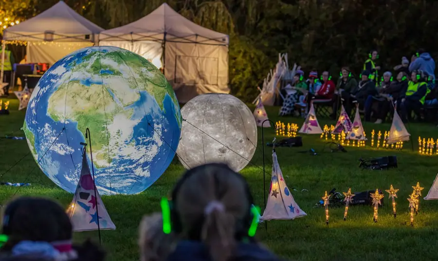Knowsley Bourgh of Culture People watching the outdoor planetarium at the Cronton Sun, Moon and Stars event