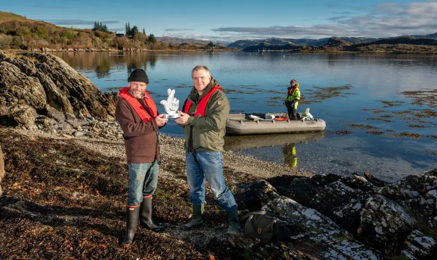 Danny Renton from Seawilding Danny stands on the shores of the loch receiving the award from Ray Mears