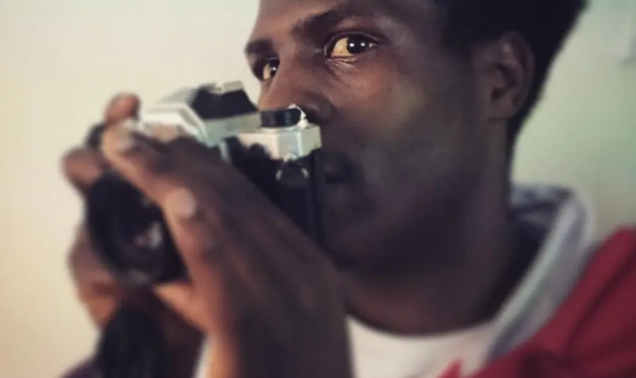 A young man with a camera