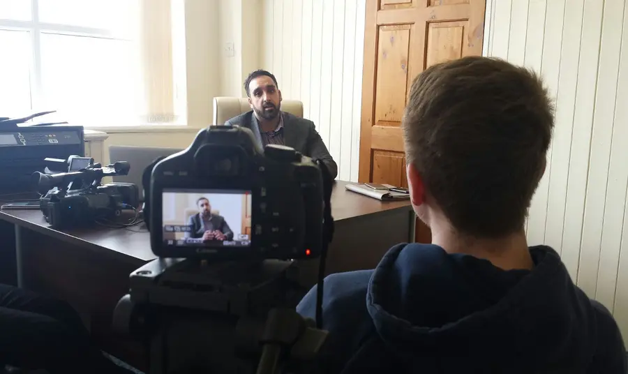 Our Past - Our Present Young volunteer interviewing participant on the subject of their experience of British life