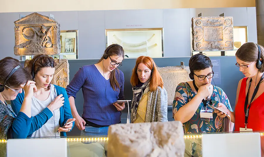 Heritage leaders reveal their path to digital success Six people using devices at a museum exhibition