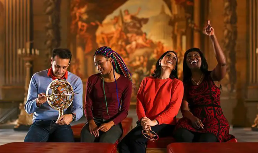 Our Values and Behaviours Four people sitting with large artwork behind them