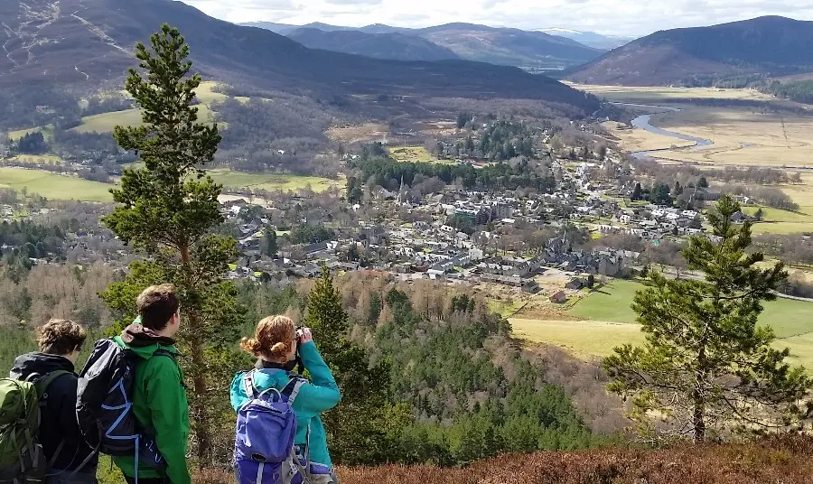 Heritage Horizon Awards Three people look down over a valley with mountains in the distance