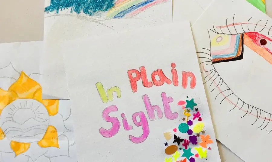 In Plain Sight poster Colourful handmade poster for the In Plain Sight project. Rainbows, flowers and an eye decorated with LGBTQ+ colours can be seen