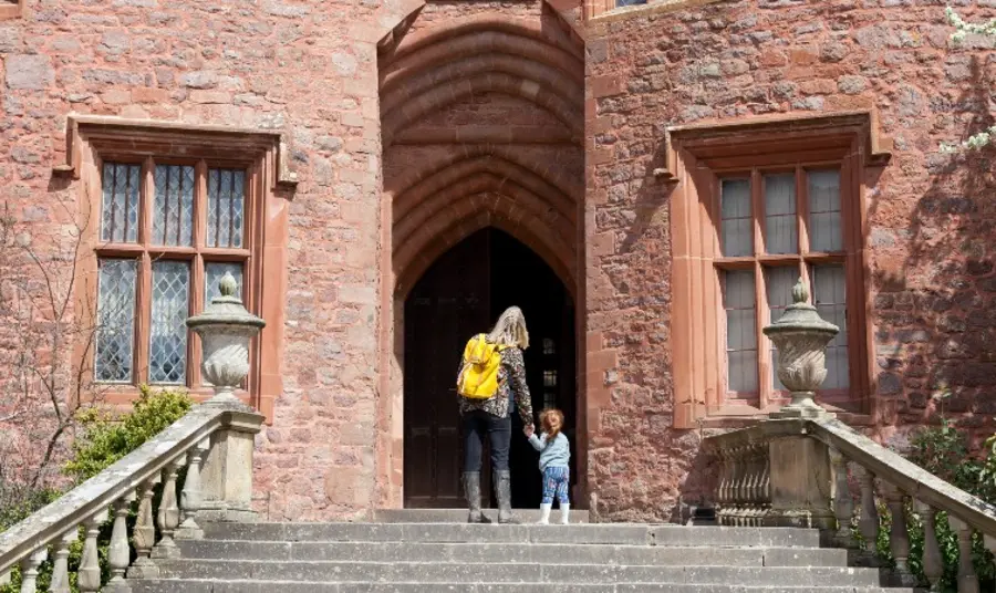 Open up your heritage to new visitors during National Lottery Open Week 2022 Adult and child entering historic building.