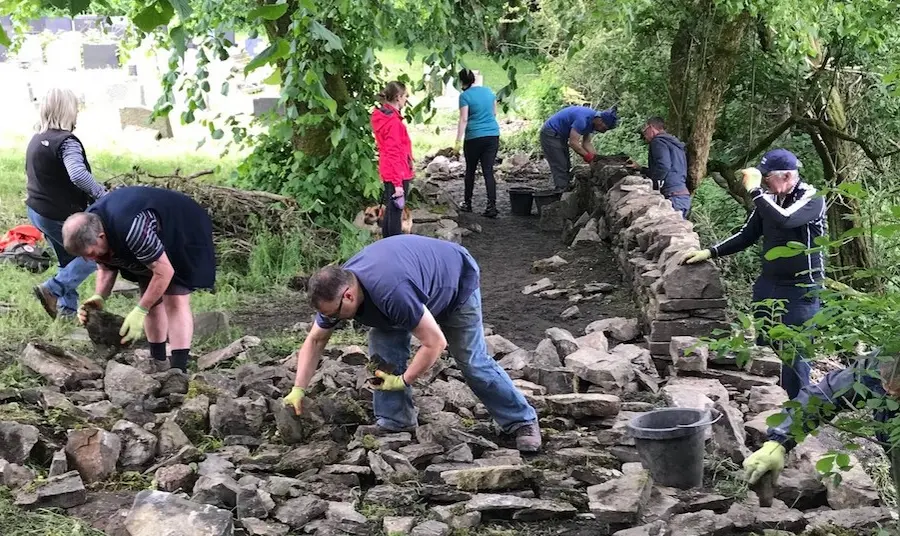 Volunteers have learned new skills so they can care for St Nicholas Church's dry stone walls in Rossendale, Lancashire Volunteers work on rebuilding dry stone walls at St Nicholas Church,