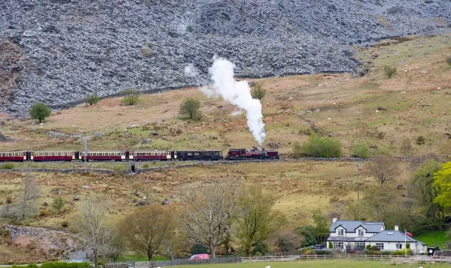 Steam train with slag heaps in background Steam train with slag heaps
