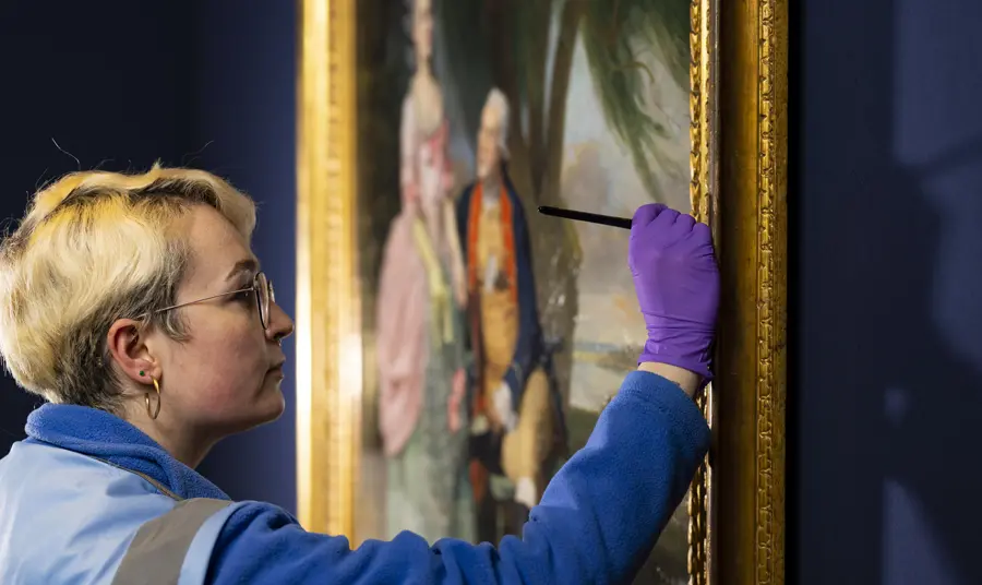 The reopening of the National Portrait Gallery. Credit: David Parry A close up of a person conserving a painting on display in the National Portrait Gallery