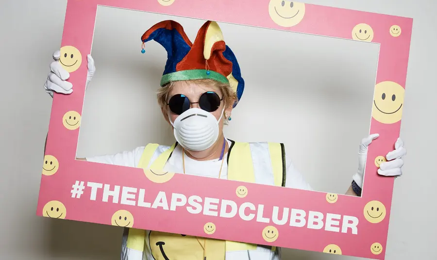 Memories, Communities & Belonging: The Lapsed Clubber Heritage Map of Greater Manchester 1985-1995 A lapsed clubber holding a picture frame, dressed in typical clubbing paraphernalia from the late 80s