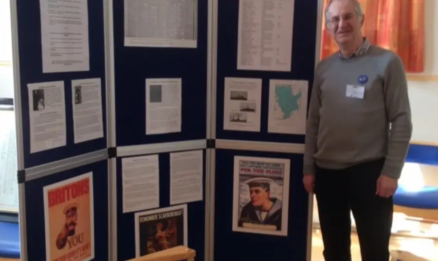 The impact on the people of Portsmouth of the Battle of Jutland A man standing by exhibition boards on the Battle of Jutland