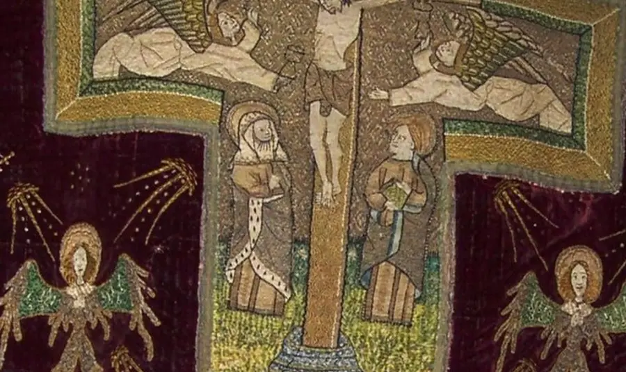 The restoration of a medieval vestment from St John's An image of a medival vestment showing a crucifix, religious figures and angles.
