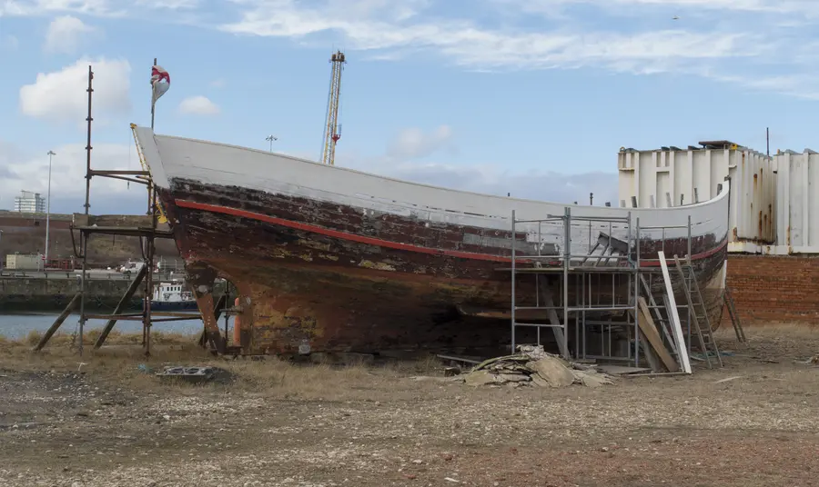 Trustee Capacity Building Project The hull of a boat being repainted