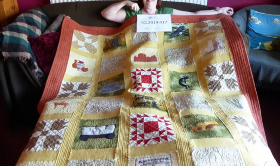 Interviewee Julie Edwards and her quilt Interviewee Julie Edwards and her quilt