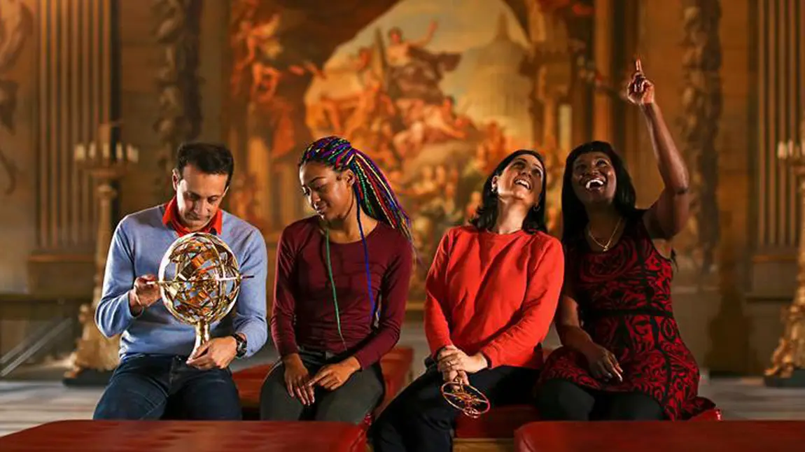 Our Values and Behaviours Four people sitting with large artwork behind them