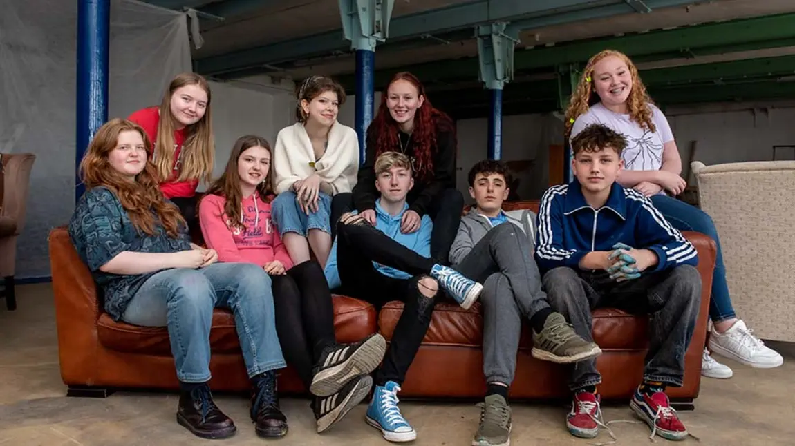 A revolution in industrial heritage Young people gathered around a red sofa