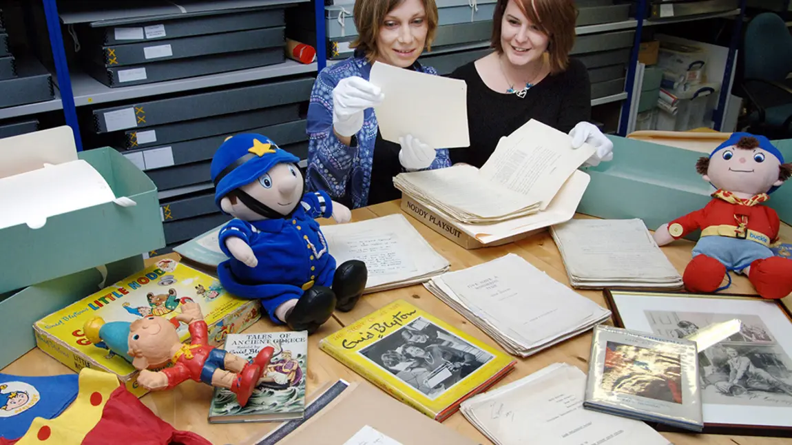 World of books and stories saved by National Lottery Collections Director Sarah Lawrance and Exhibition Manager Alison Fisher with Enid Blyton archive