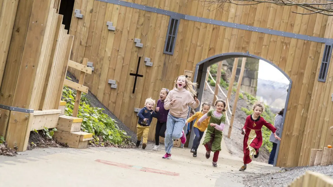 Free offers for National Lottery players at heritage sites across the UK Children running through large arch