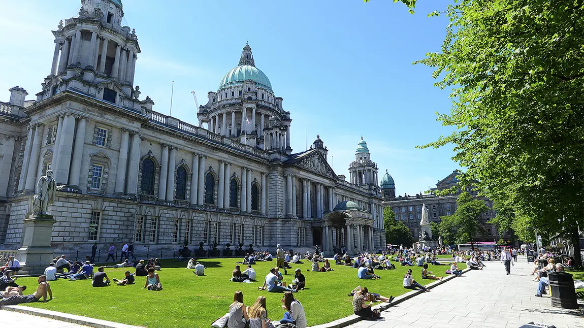 Shared History Fund: bringing people together to mark Centenary of Northern Ireland People sitting on grass in front of large building