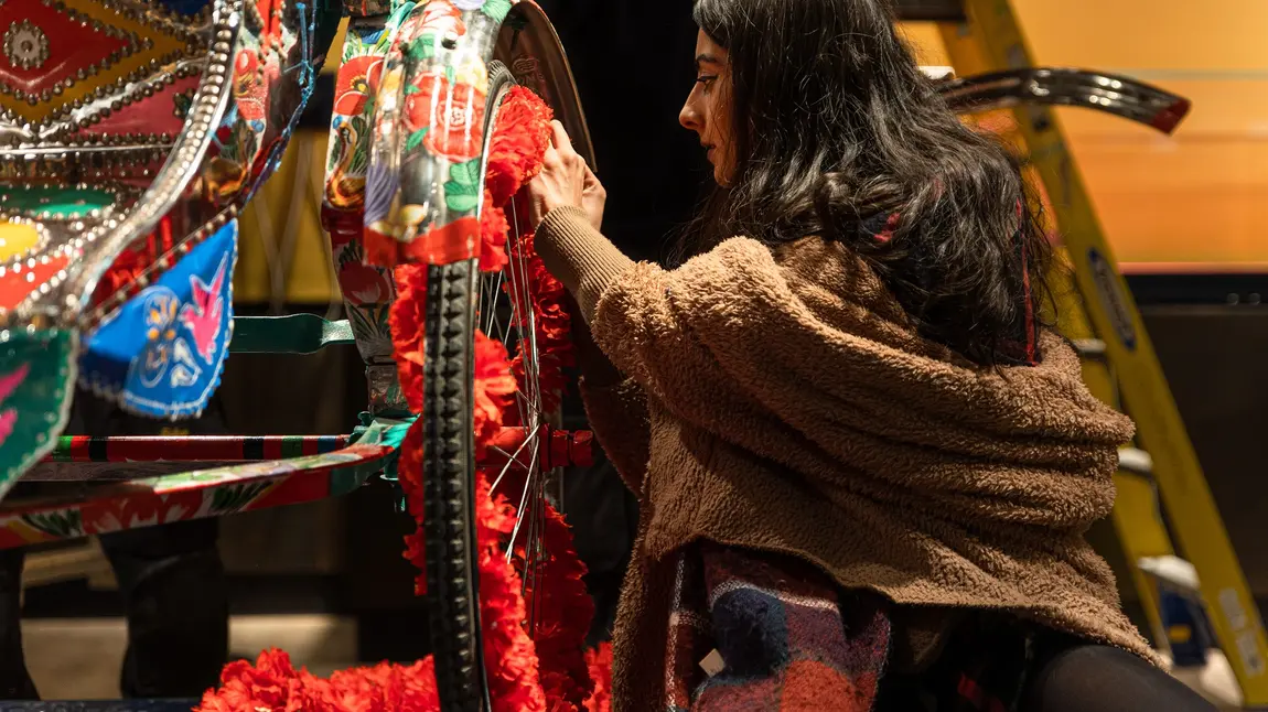 Rickshaw being painted as part of the South Asia Gallery at Manchester Museum. Credit: Manchester Museum Person painting a rickshaw on display in the South Asia Gallery at Manchester Museum