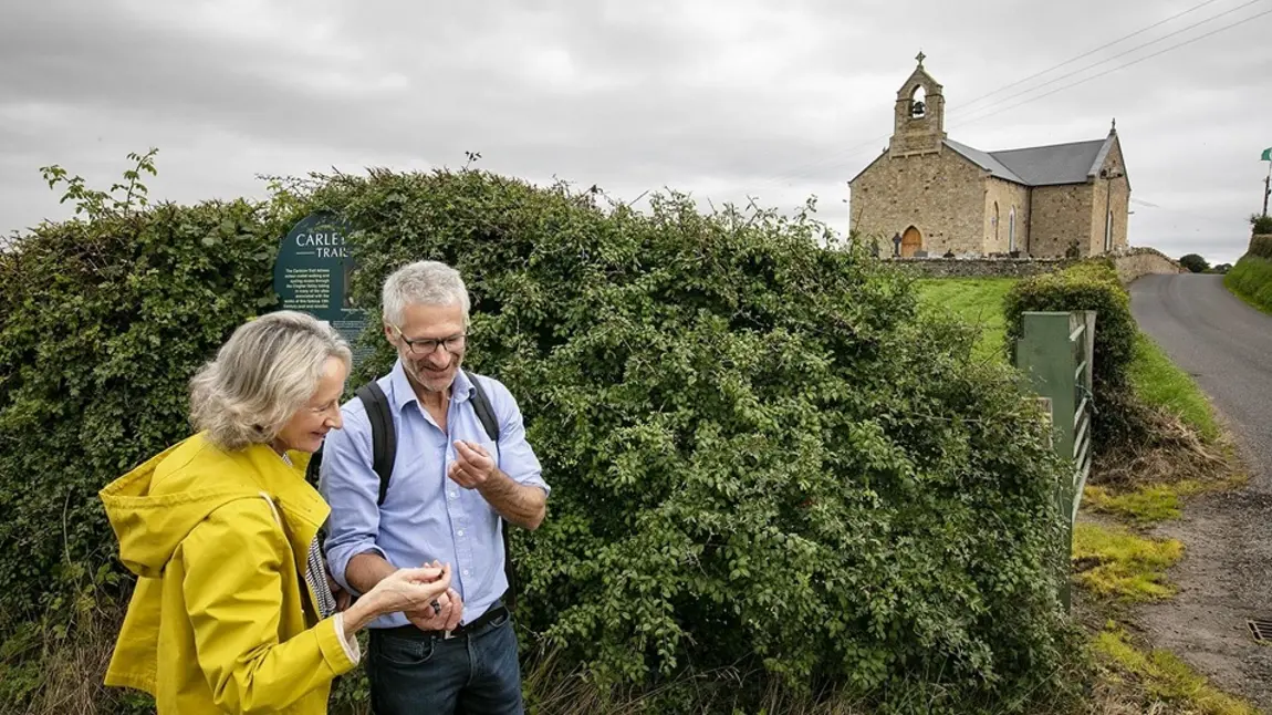 Five Northern Ireland heritage venues to explore on European Heritage Open Days Two people standing with a church on a hill in the background