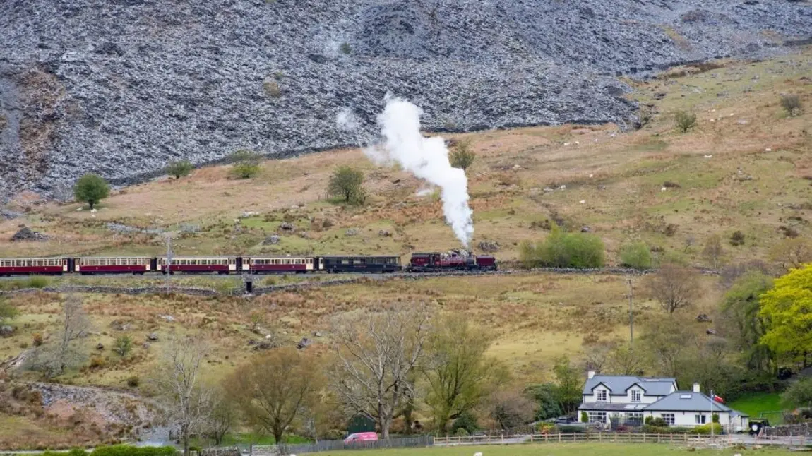 Steam train with slag heaps in background Steam train with slag heaps
