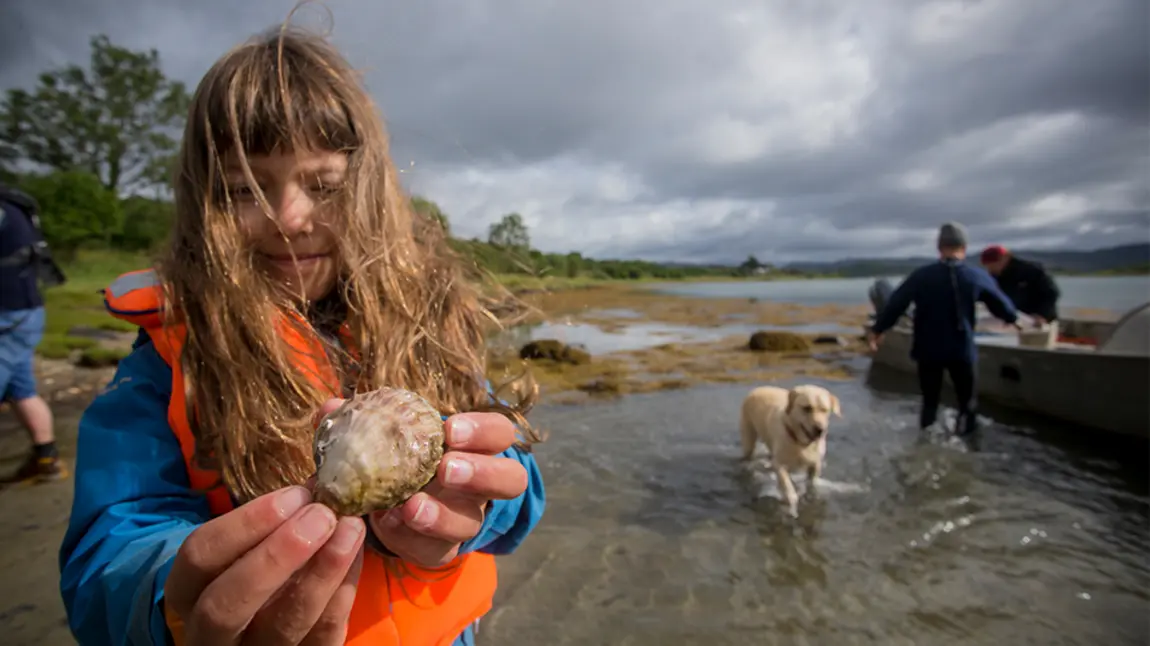 Join us in sharing your #PlanetaryPromise this week Young girl holding an oyster