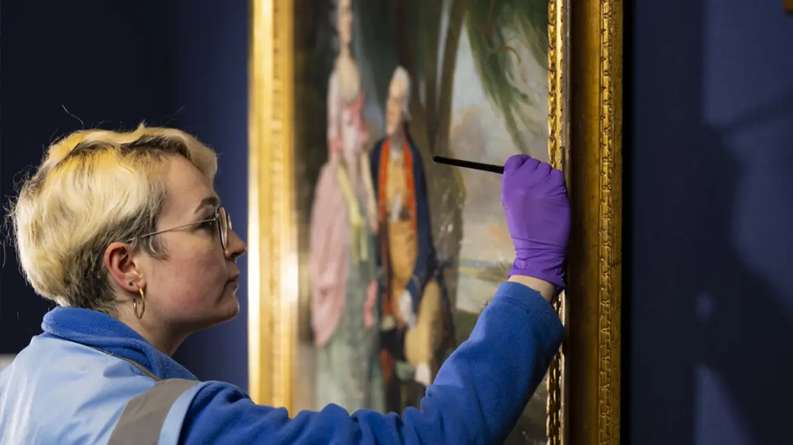 The reopening of the National Portrait Gallery. Credit: David Parry A close up of a person conserving a painting on display in the National Portrait Gallery