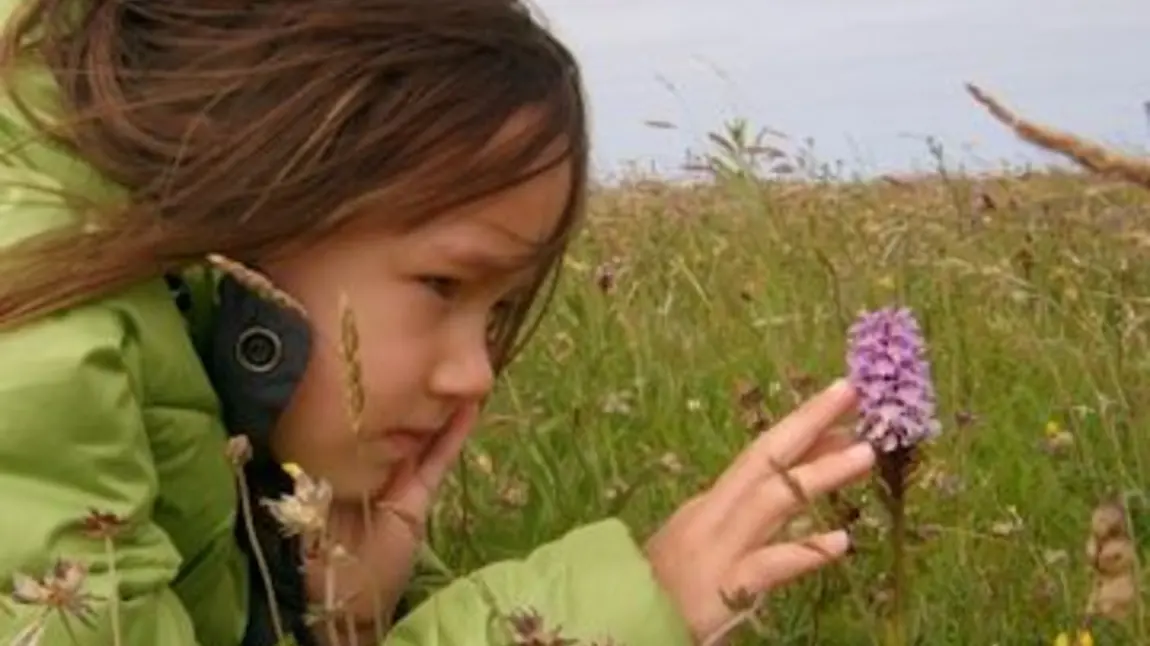 Girl looking at an orchid Girl looking at an orchid