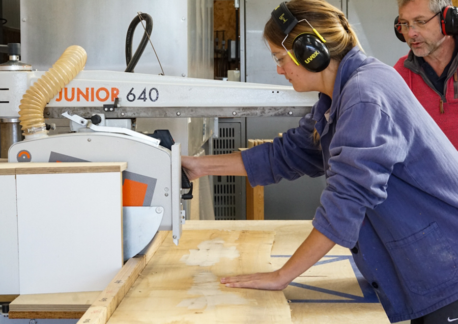 A women using a woodworking power tool